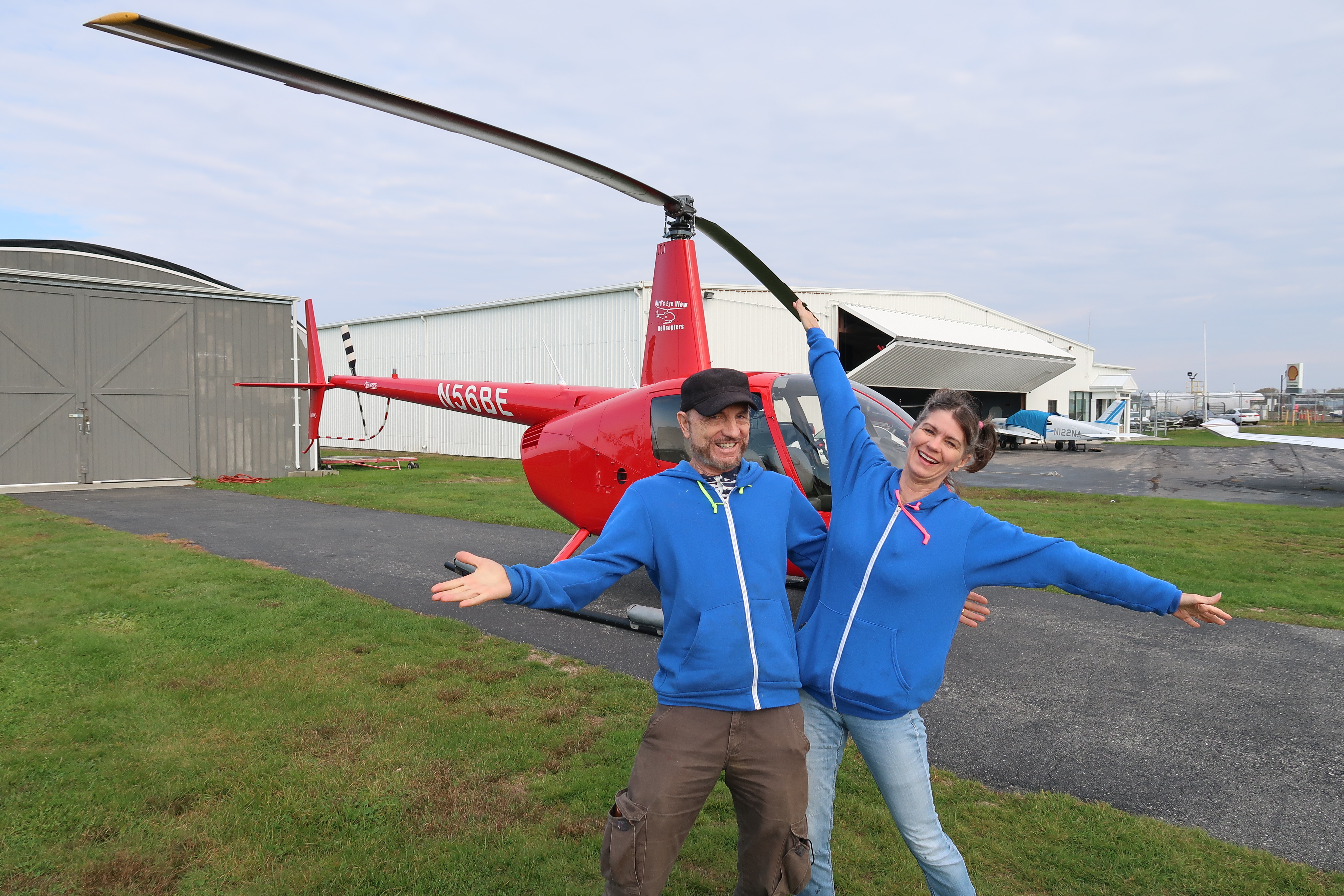 Dennis and Kimberly Goza in front of red helicopter