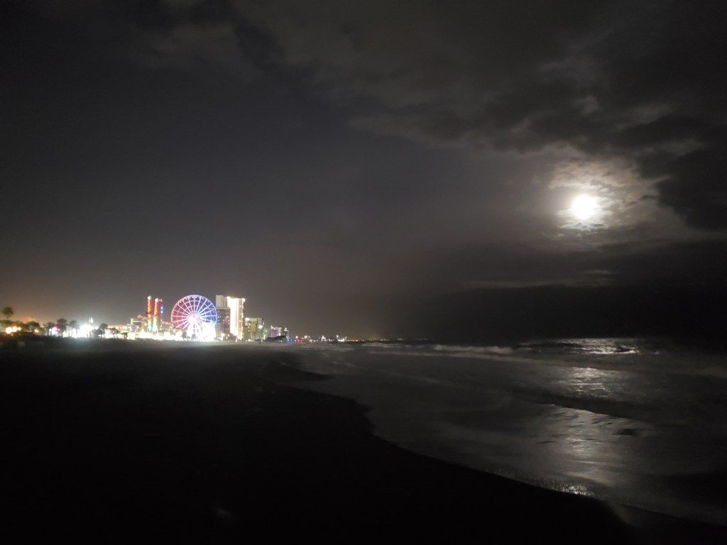 Full moon shines on Myrtle Beach, view of large ferris wheel