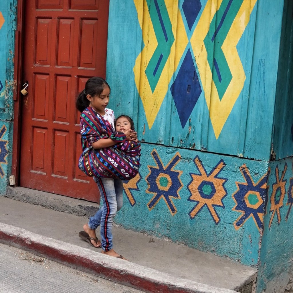 child carrying a toddler, Guatemala