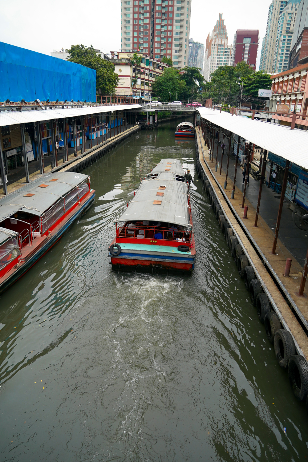 frugal travelers observe how the locals get around. Canal boats in Bangkok.