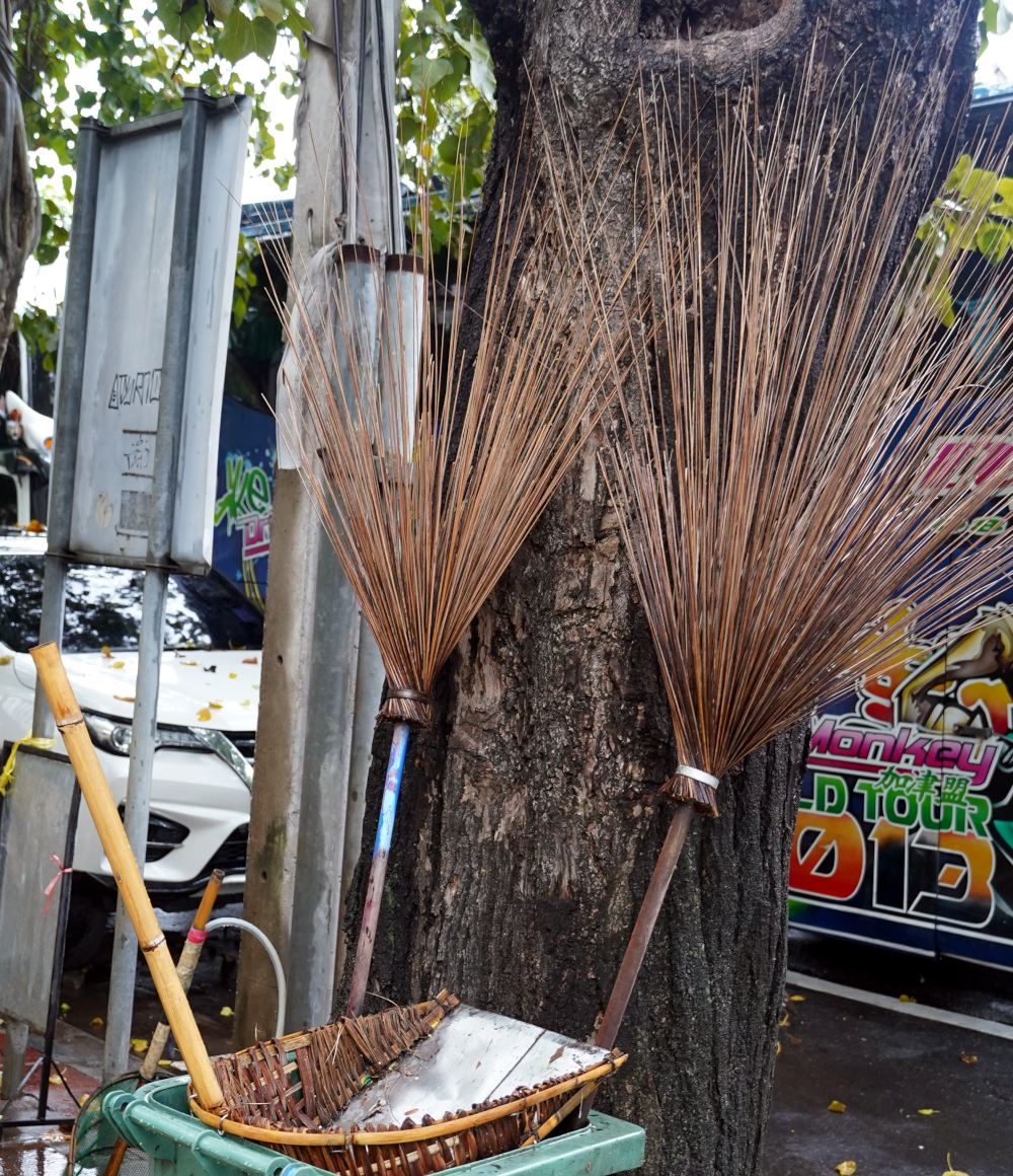 street scene - two homemade stick brooms