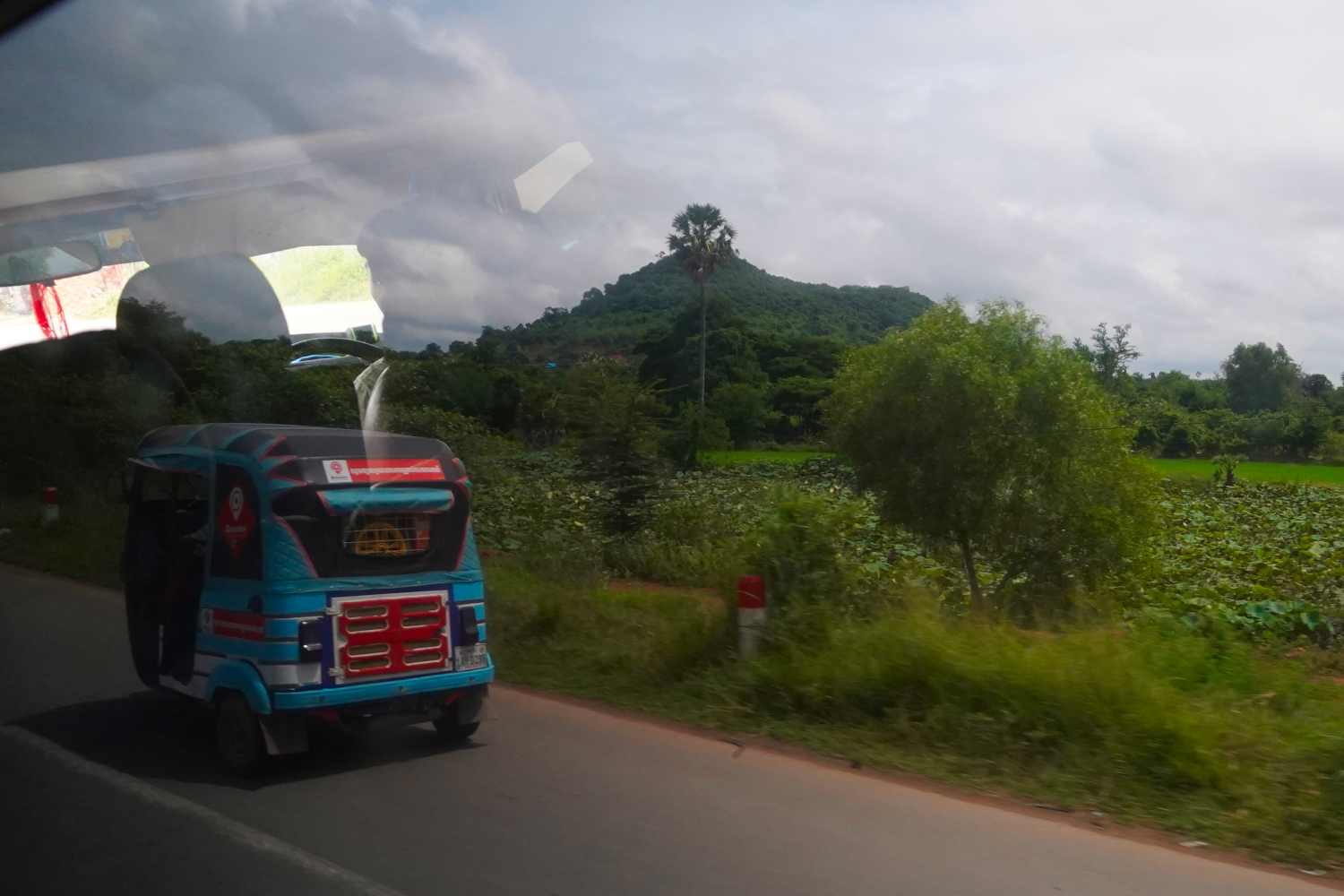 passing a tuk tuk along the road