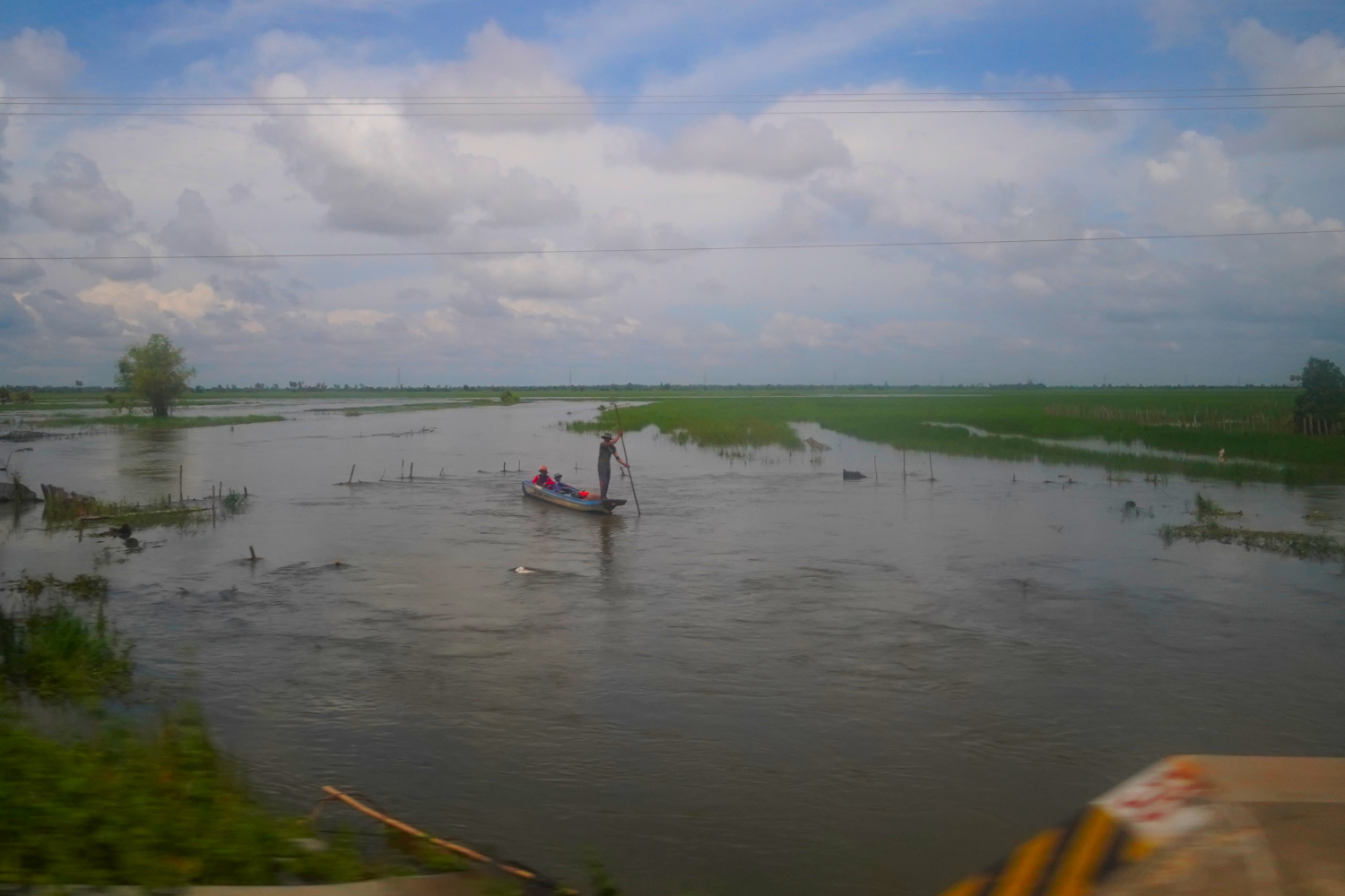 family traveling by boat in Cambodia