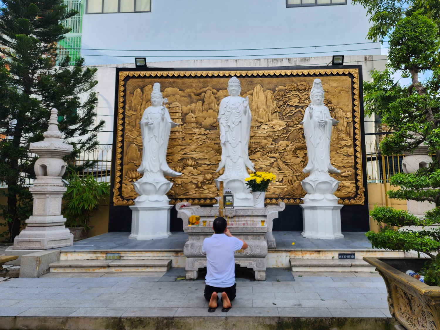 man offering prayers, Vietnam