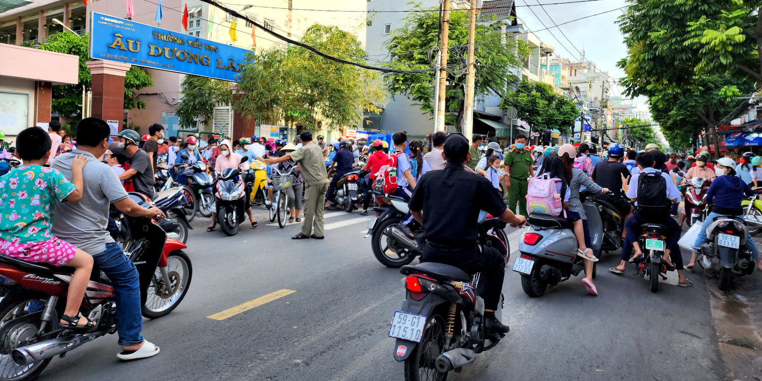 streets crowded with parents on motos picking up kids after school, Ho Chi Minh, Vietnam