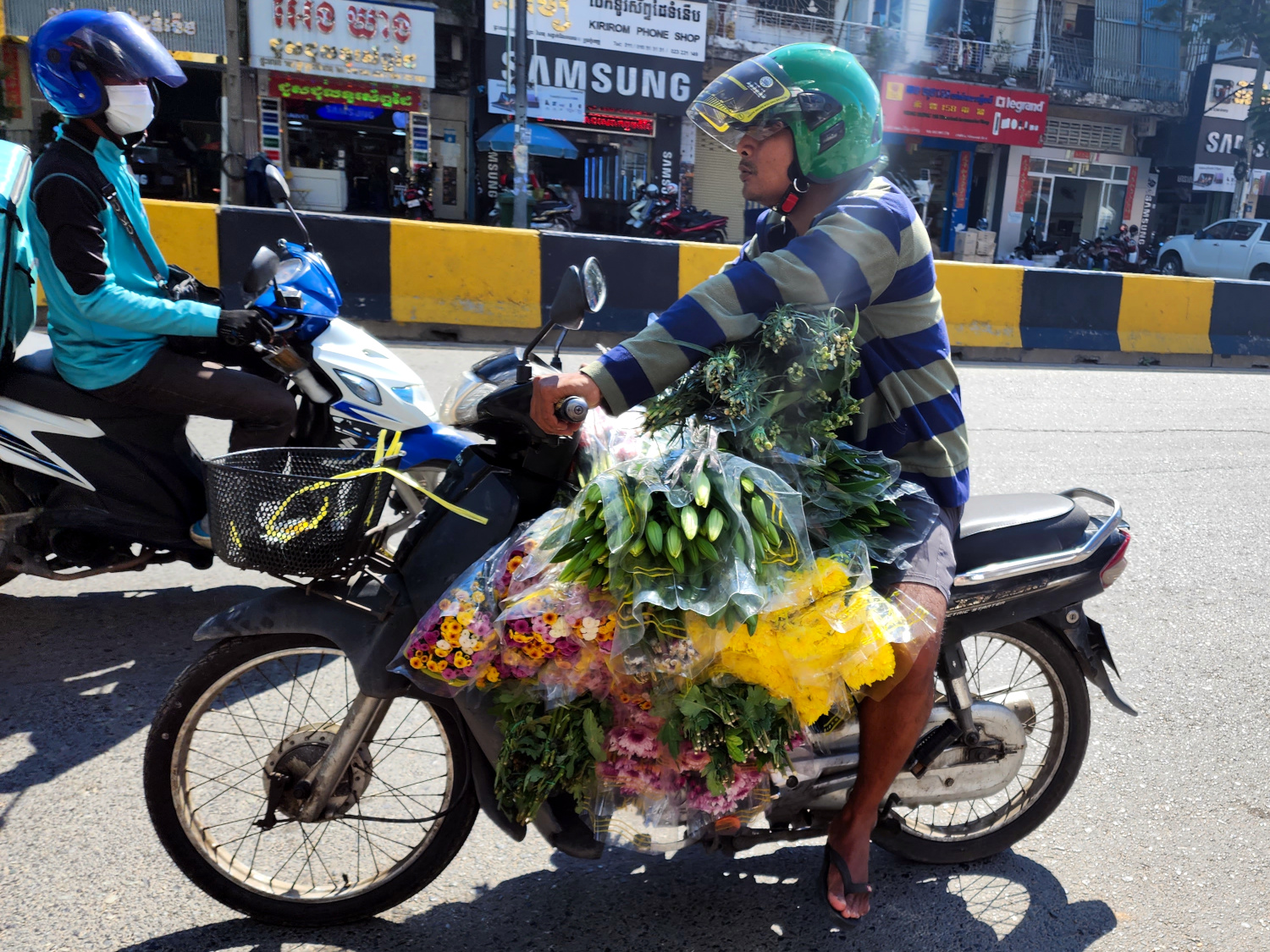 hauling fresh flowers on a moto in Phnom Penh