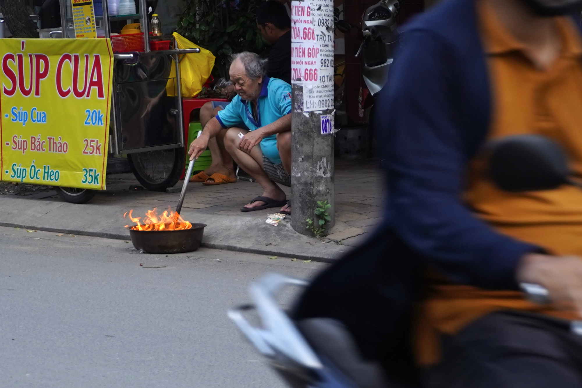 burning garbage or cooking with flames on the street in Ho Chi Minh