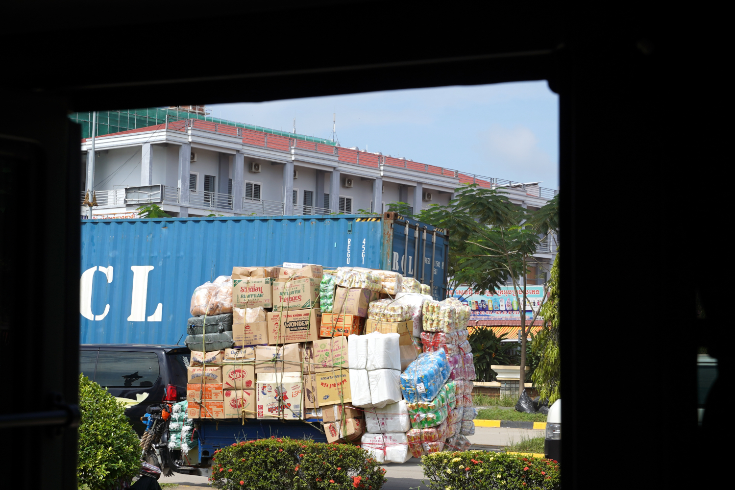 tuk tuk loaded with cargo crossing Vietnam / Cambodia border