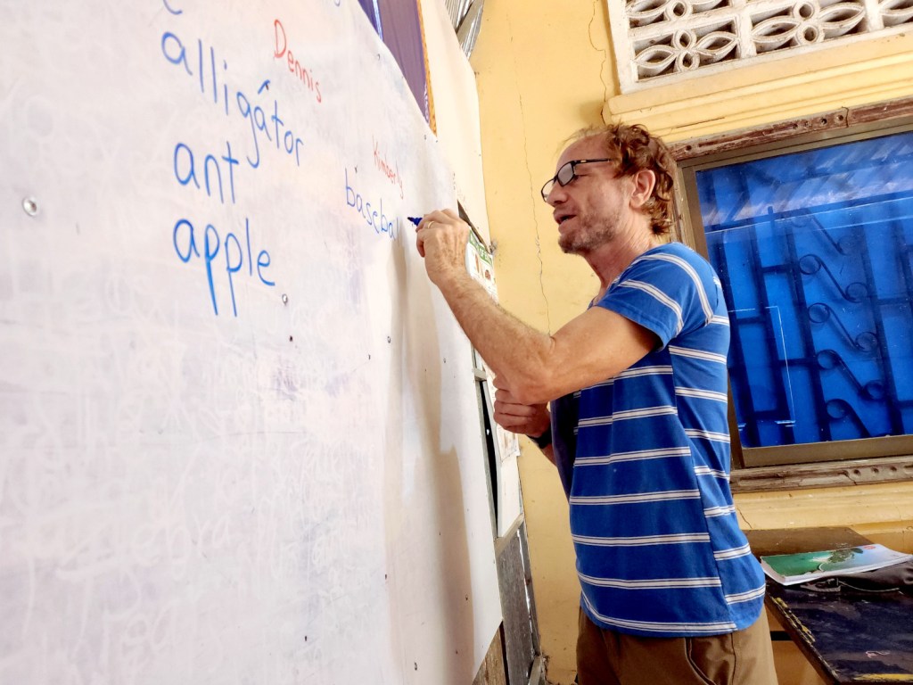 Dennis volunteer teaching English class