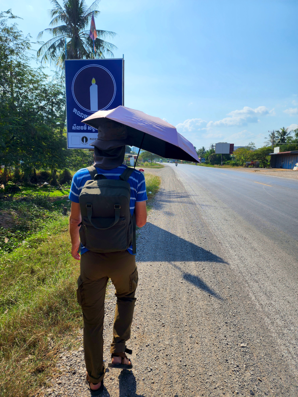 using an umbrella in the hot sun, walking home