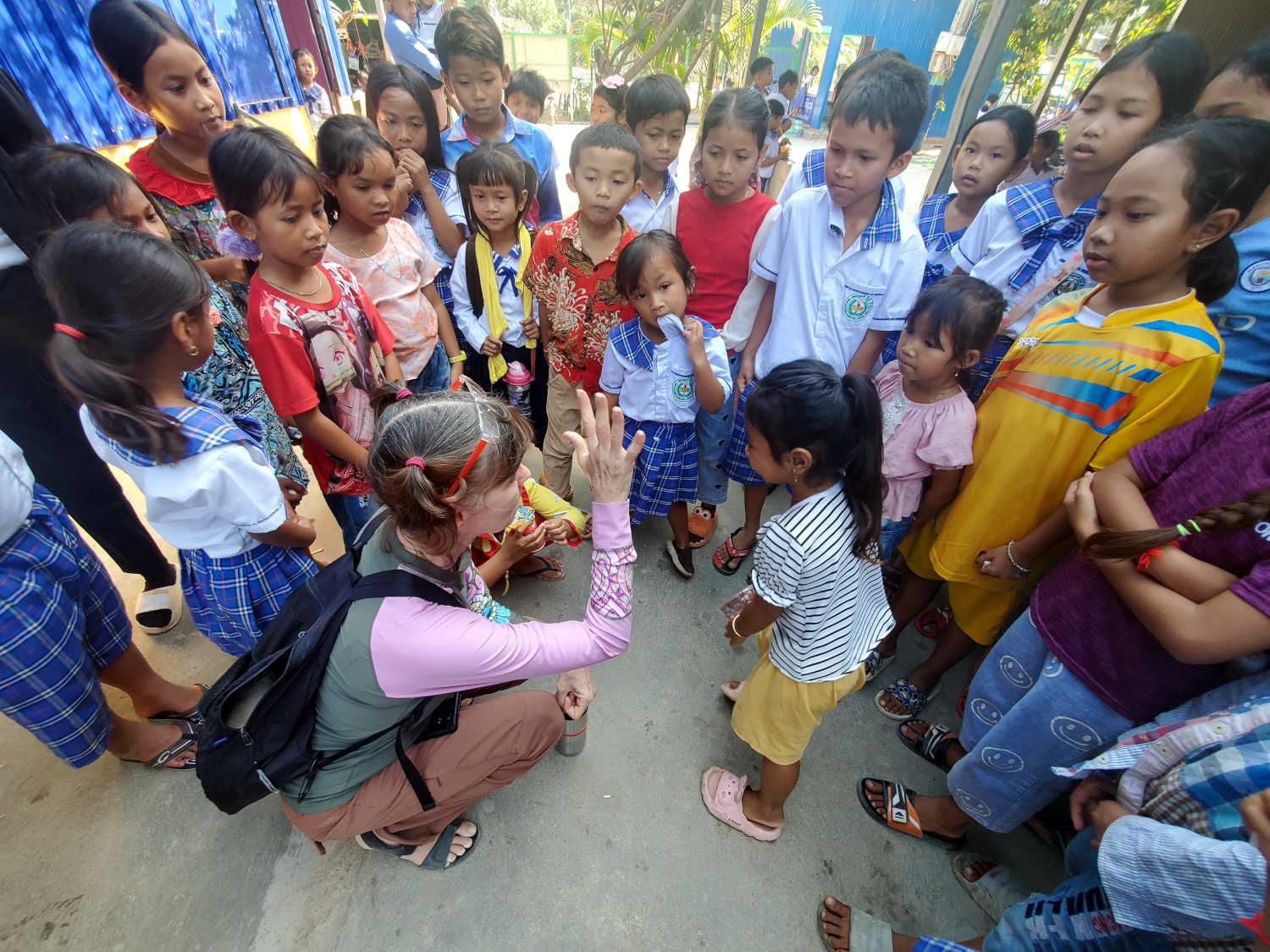 students with volunteer teacher between classes