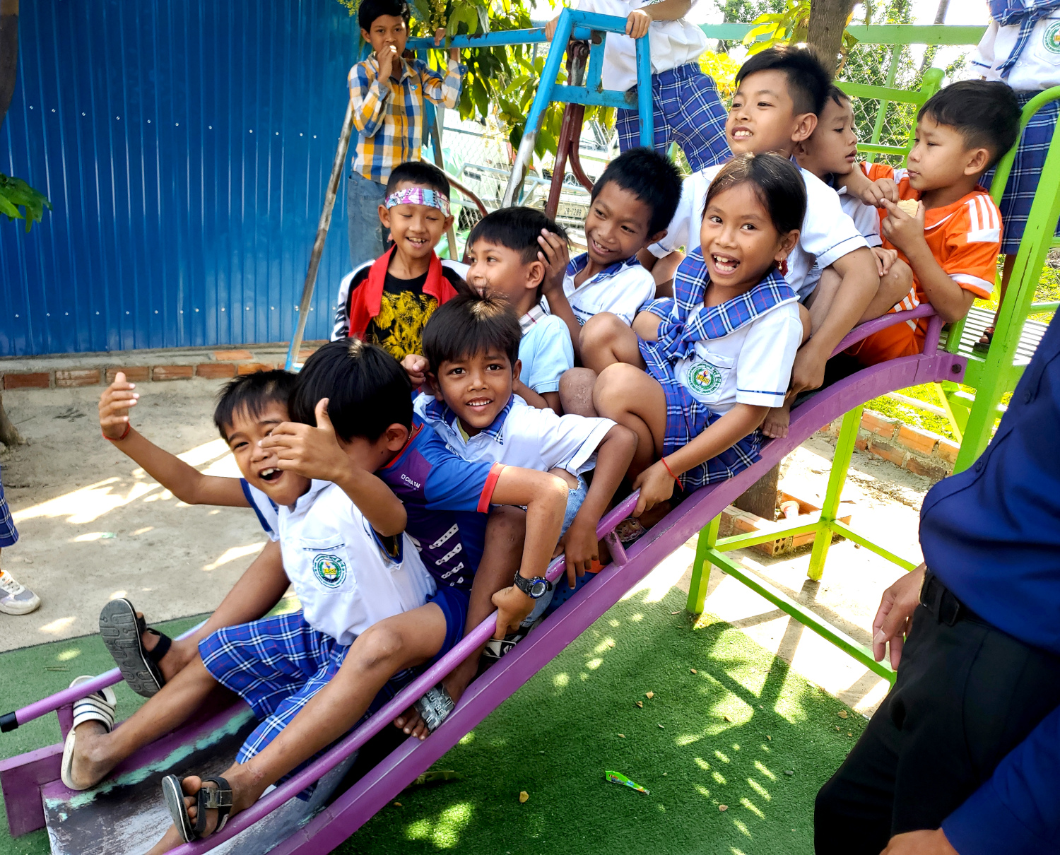 students on a slide in Phnom Sampov