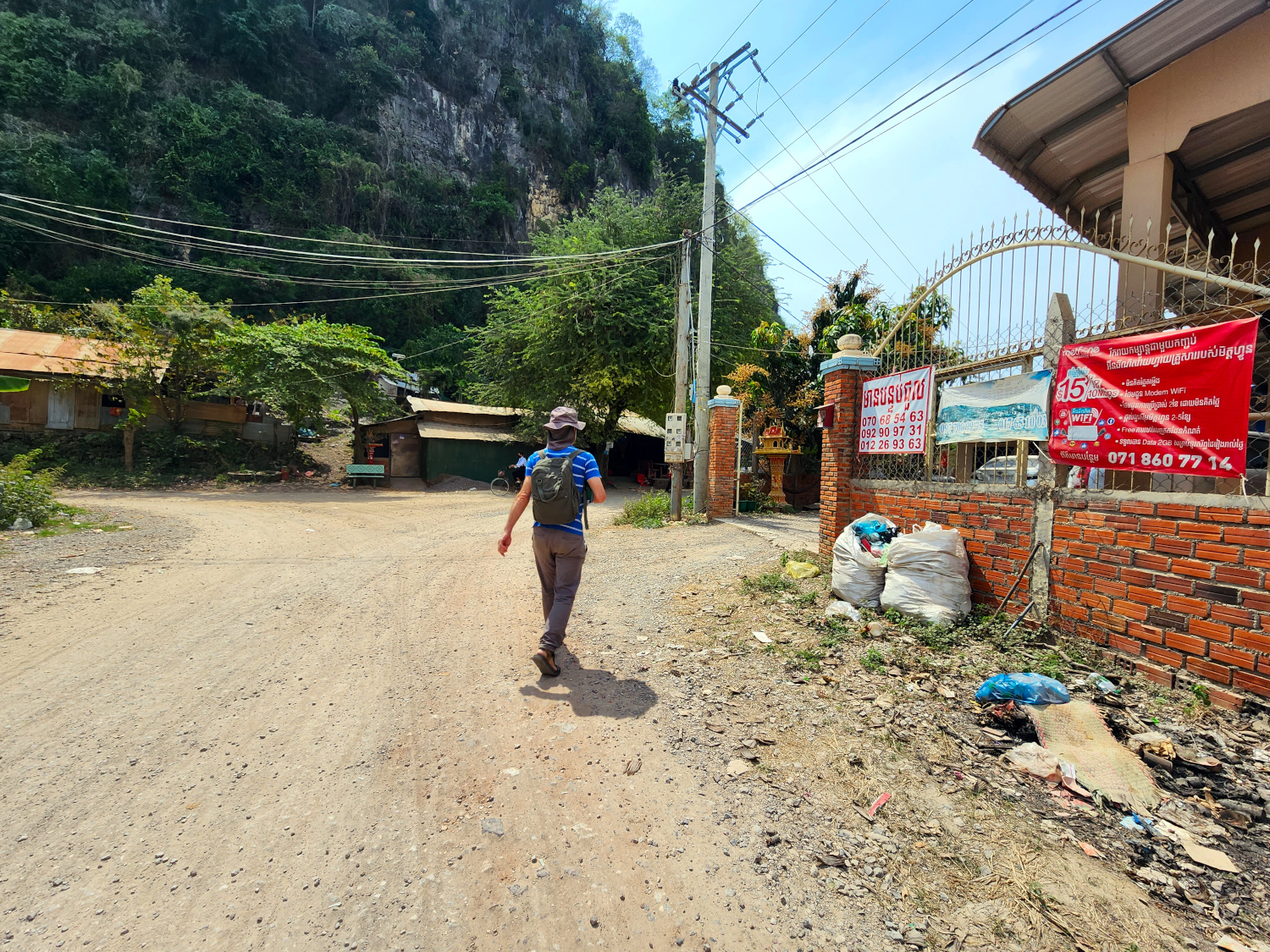 going home on the dusty streets in Phnom Sampov