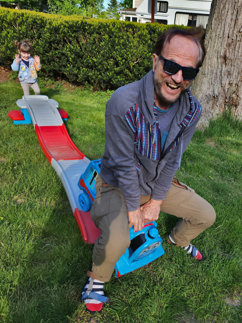 adult playing train with kid Massachusetts, USA